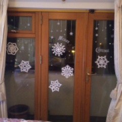 My paper snowflakes and stickers on my bedroom window
